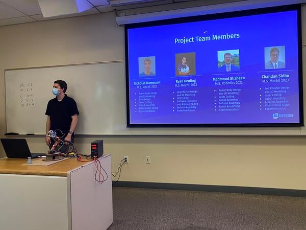 man presenting at front of classroom